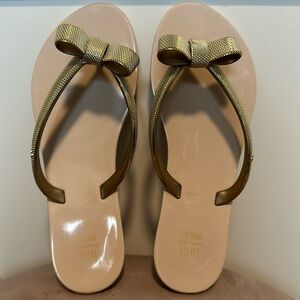 Gold and beige gorgeous Mel by Melissa flip flops in size 3.